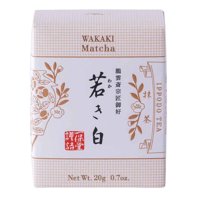 New unopened beige box of Ippodo Tea Co. Wakaki matcha with Japanese characters and gold leaf flowers embossed on white
