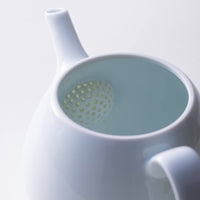 Snow white glazed porcelain symmetrical shape Japanese Hasami-yaki kyusu teapot with lid off revealing half dome strainer