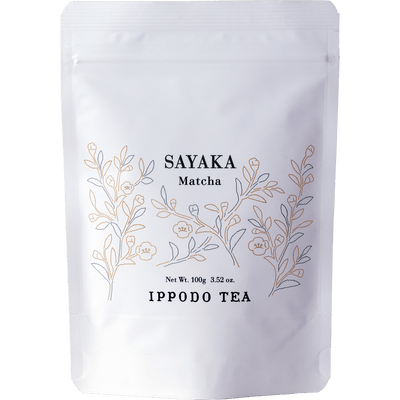 White resealable 100 gram bag of Ippodo Sayaka matcha with gold minimalist floral design