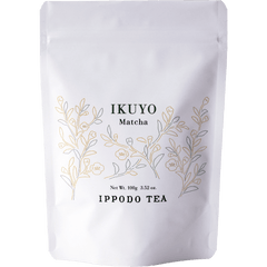 White 100 gram bag of Ippodo Tea Ikuyo matcha powder for with line drawing of gold and green leaves of the tea plant
