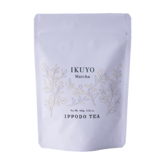 White 100 gram bag of Ippodo Tea Ikuyo matcha powder for with line drawing of gold and green leaves of the tea plant