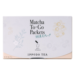 Slim peach color box of Matcha-To-Go Packets with light grey flap to open on front with faint multicolored flowers petals
