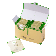 Open cream box containing 25 individually wrapped Sencha Teabags beside one teabag packet with green corners and Ippodo logo