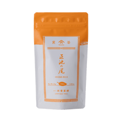 White packaging with orange faux-painted details for Shoike classic Japanese Sencha green tea 80g bag by Ippodo Tea Co.