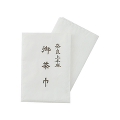 White chakin hemp tea cloth decorated with black Japanese kanji characters used for tea ceremony