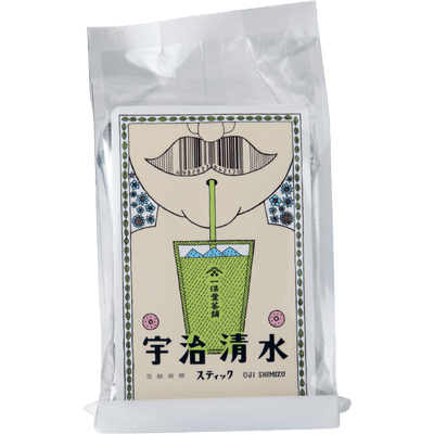 Foil package of Uji-Shimizu matcha with cartoon man with no shirt and sipping matcha through a straw behind Japanese writing