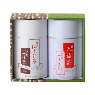 Green tea canister gift set with two white cans with white and red Japanese writing set inside green and brown decorative box