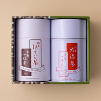 Green tea canister gift set with two white cans with white and red Japanese writing set inside green and brown decorative box