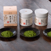 Sealed boxes of three Japanese Ippodo Tea matchas included in set alongside samples of each sprinkled loose on small plates