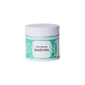 Unopened tin of New Harvest Matcha with iconic Ippodo tea pot and floral design in bright green against white background