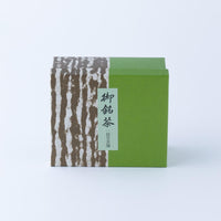 Box half green and half brown tree bark design with black Japanese text 'Omeicha Ippodo'