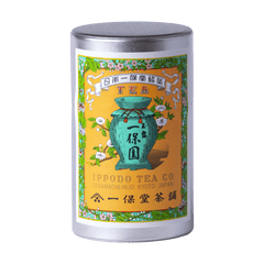 Tea canister with iconic colorful label featuring a green teapot and floral design with Japanese characters