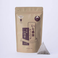 Beige and burgundy tea package with a pyramid-shaped tea bag on a white background