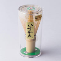 Korean artisan-made Chasen 80-tip bamboo matcha whisk tea utensil in case with Japanese characters on white background