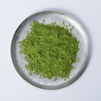 Vibrant dark green loose Japanese Ippodo Tea New Year's Matcha 2025 powder on silver plate on white table