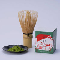 Ippodo Tea Koma-Mukashi (New Year's Matcha 2026) box, bamboo whisk, and matcha powder on a dish.