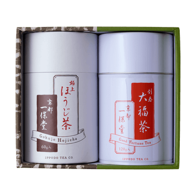 Green tea canister gift set with two white cans with white and red Japanese writing set inside green and brown decorative box