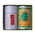 Green and brown box containing two tea canisters one colorful and one red and white label