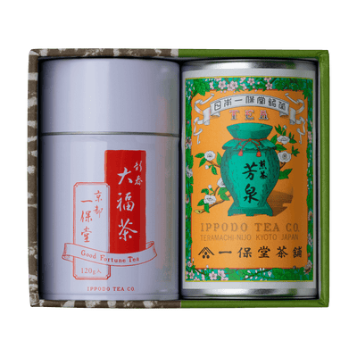 Green and brown box containing two tea canisters one colorful and one red and white label