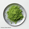 Loose green finely ground milled Japanese Ippodo Premium Select Matcha tea powder on silver plate on white table