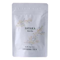 White resealable 40 gram bag of Ippodo Sayaka matcha with gold and green floral design and text