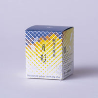 Side view of yellow and orange geometric pattern, with leaves and Japanese and English text on white background