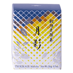 Front view of unopened tea box with blue and yellow geometric pattern, flowers and Japanese and English text