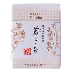 New unopened beige box of Ippodo Tea Co. Wakaki matcha with Japanese characters and gold leaf flowers embossed on white