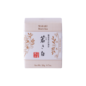 New unopened beige box of Ippodo Tea Co. Wakaki matcha with Japanese characters and gold leaf flowers embossed on white