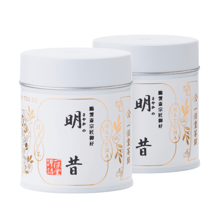 Two white tin cans of rich bestseller Sayaka matcha by Ippodo Tea with Japanese characters and gold leaf