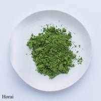 Jungle green loose finely milled Japanese Ippodo Tea Horai Horai-no-mukashi matcha powder on white plate on white table