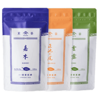 Three resealable 80g packages of Ippodo sencha tea colored indigo, orange and green respectively overlapping each other