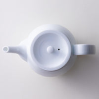 Top view of sleek snow white glazed porcelain symmetrical shape Japanese Hasami-yaki kyusu teapot
