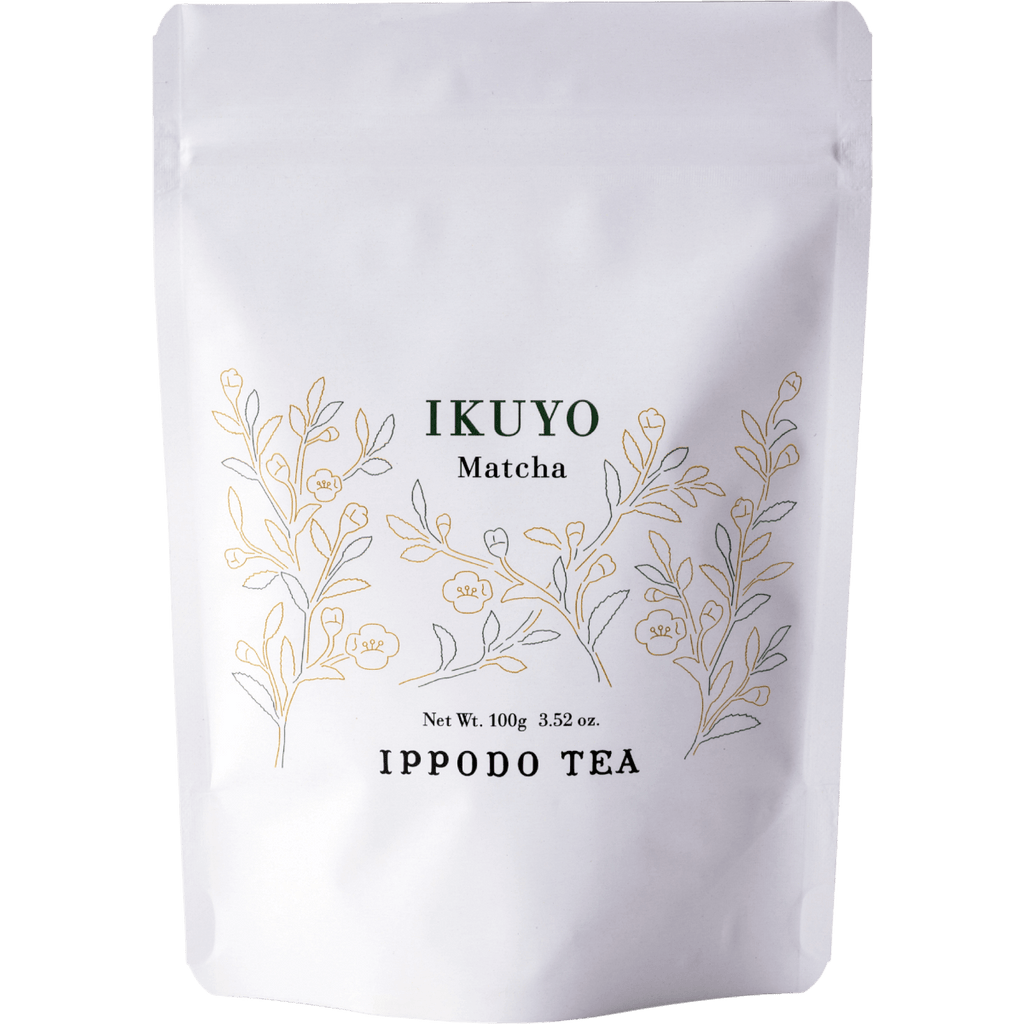 White 100 gram bag of Ippodo Tea Ikuyo matcha powder for with line drawing of gold and green leaves of the tea plant