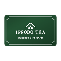 Green gift card that reads 'IPPODO TEA USD$100 GIFT CARD' with Ippodo Tea logo and white border against white background