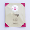 Single individual cream package of One-Cup Teabag of Ippodo Gyokuro Tea with pink corners and logo on shiny circle, Japanese