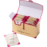 Open cream box containing 25 individually wrapped Gyokuro Teabags beside one teabag packet with pink corners and Ippodo logo