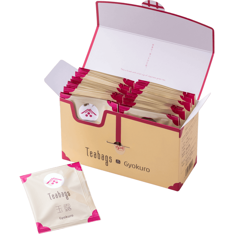 Open cream box containing 25 individually wrapped Gyokuro Teabags beside one teabag packet with pink corners and Ippodo logo