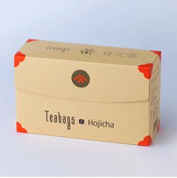 Sealed long beige box of 25 Hojicha Teabags with orange corners, easy open tab and Ippodo Tea logo on bronze circle