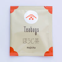 Individually wrapped beige packet of Ippodo Hojicha roasted tea Teabag with orange corners and Japanese writing