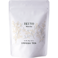 White 100 gram bag of Ippodo Tea Ikuyo matcha powder for with line drawing of gold and green leaves of the tea plant