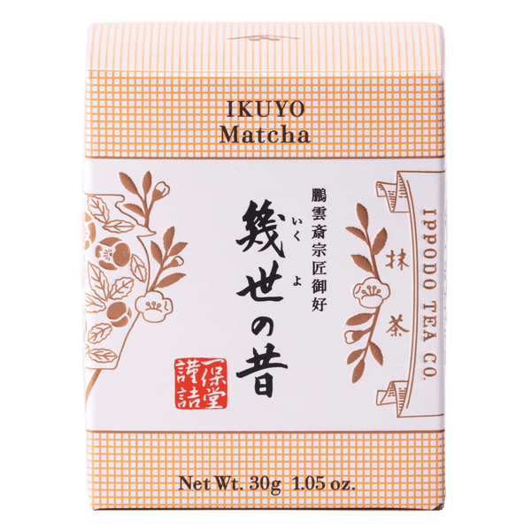 Unopened box of Ippodo Tea Co. Ikuyo matcha powder with peach color hashmarks, Japanese characters and gold flowers leaves