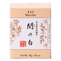 Brand new beige unopened box of Ippodo Tea Co. Kan matcha powder with Japanese characters and gold leaf flowers embossed