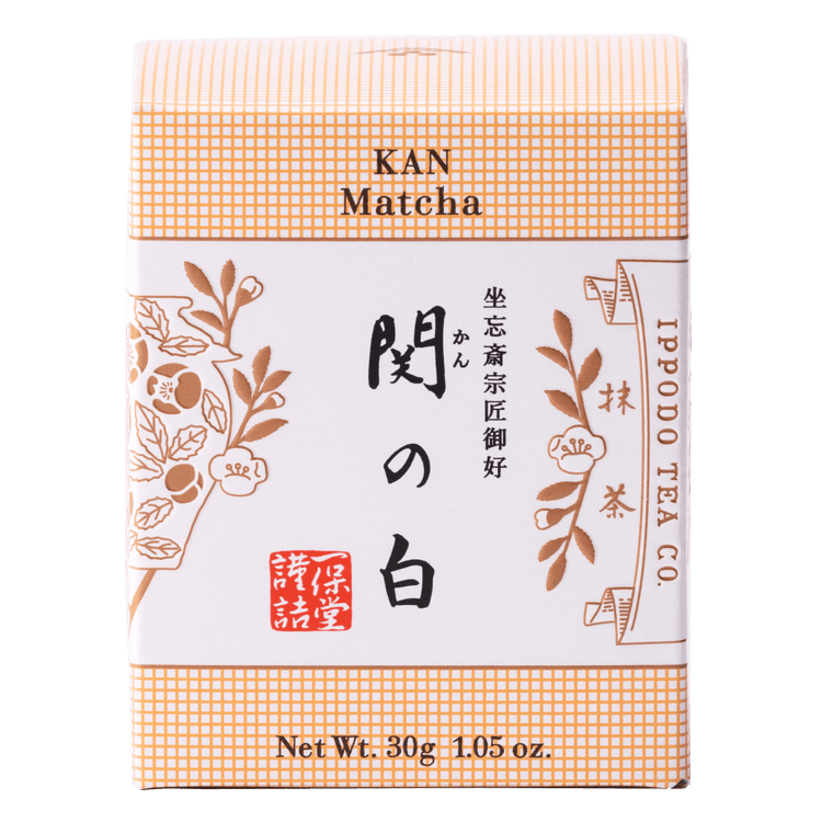 Brand new beige unopened box of Ippodo Tea Co. Kan matcha powder with Japanese characters and gold leaf flowers embossed