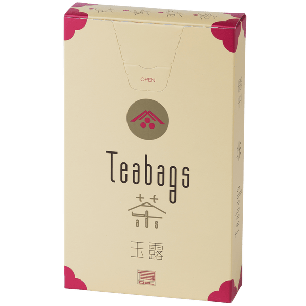 Sealed tall, cream box of 12 Ippodo Gyokuro One-Cup Teabags with pink corners and logo on bronze circle and easy open tab