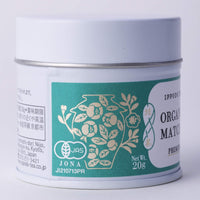 JAS Certification seal shown on teal and gold tin of Premium Organic Matcha with iconic Ippodo tea pot and floral design