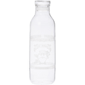 A clear glass bottle with a narrow neck and wide body. It appears empty and has some etched or printed design on its surface, though the details aren't clearly visible. The bottle has a simple, cylindrical shape typical of water or juice bottles, with a slight lip at the top where a cap would typically be placed. The glass is transparent and clean.
