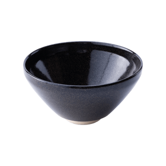 Sleek shiny cone shaped speckled black glazed ceramic matcha tea bowl with light-colored unglazed base