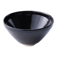 Sleek shiny cone shaped speckled black glazed ceramic matcha tea bowl with light-colored unglazed base