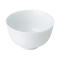 White porcelain Japanese teacup with slight curve outwards at lip against plain background